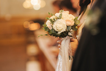 Element of decor in the church. Wedding bouquet in hands