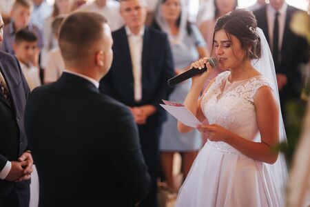Baeutiful wedding couple in the church. Just married groom and bride. Familyの写真素材