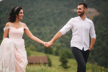 Beautiful wedding couple in Carpathian mountains. Handsome man with attractive womanの写真素材