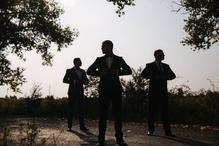Silhouette of tree man in suit outsideの写真素材