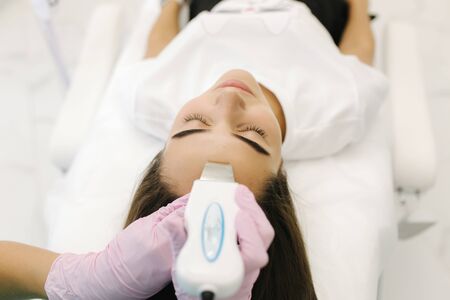 First-person view of cosmetologist doing beauty procedure at cosmetology clinic.の写真素材