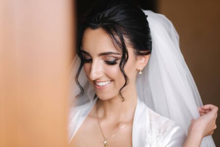 Close up portrait of gorgeous bride at hotel in morning. Charming woman with great hairstyle and makeupの写真素材