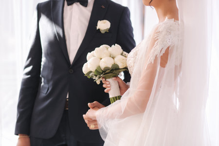 Middle selection of newlyweds putting the rings to each other.