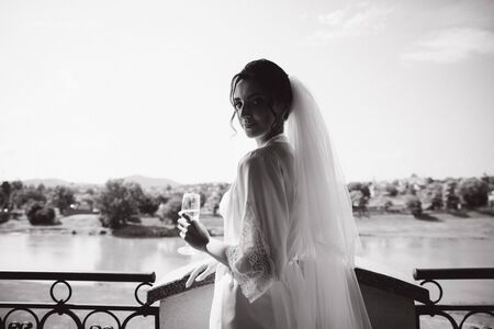 Morning of beautiful bride. Woman in white negligee in hotelの写真素材