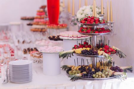 Sweet deserts on the table. Different desserts on candy barの写真素材