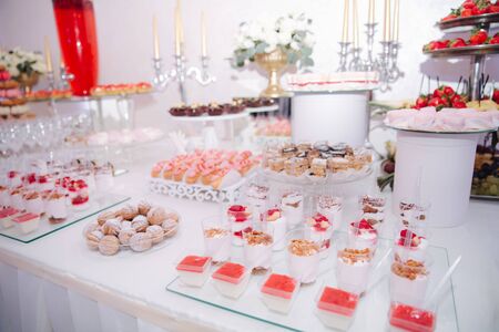 Sweet deserts on the table. Different desserts on candy barの写真素材