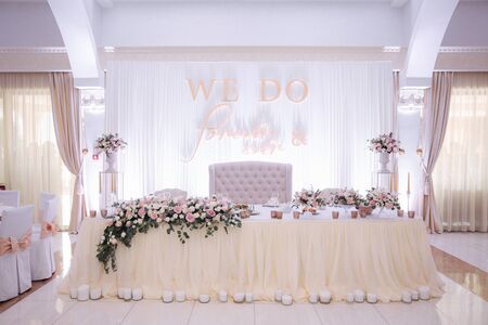 Decorated table for wedding celebration. Bright restaurand with a lot of windows.の写真素材