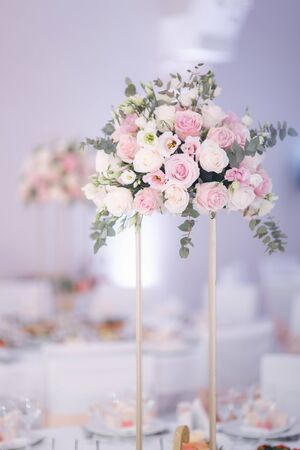 Decorated table for wedding celebration. Bright restaurand with a lot of windows.の写真素材
