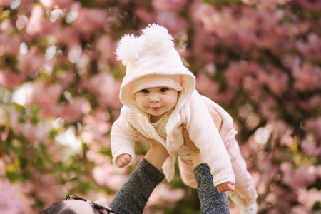Portrait of cute little baby girl outside with mom. Beautiful girl smile. Five month baby. Happy...