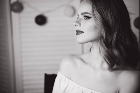 Portrait of beautiful blond hair lady after makeup in beauty studio. Black and white photo. Ring lampの写真素材