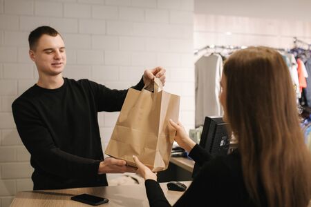 Happy customer with shopping bag in clothing roomの写真素材