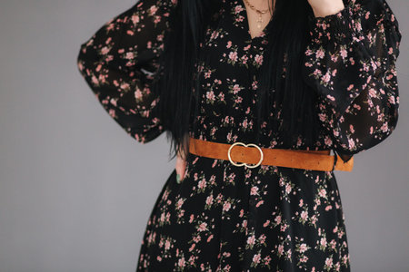 Young brunette model demonstating spring clothes in studio