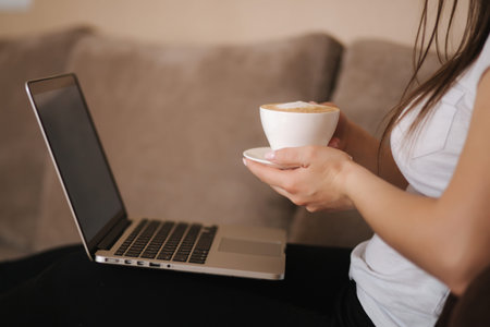 Middle selection of foung woman work at home in quarantine. Woman use laptop on sofa. Woman study...