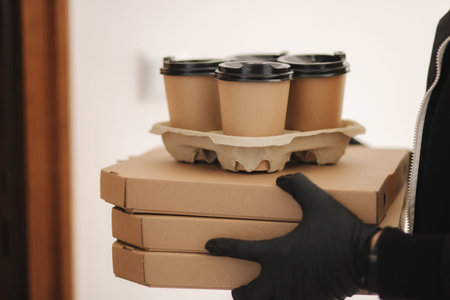 Close up delivery boy give order to customer. Pizza and coffee devilery. Delivery boy and customer...