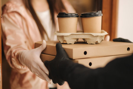 Close up delivery boy give order to customer. Pizza and coffee devilery. Delivery boy and customer...