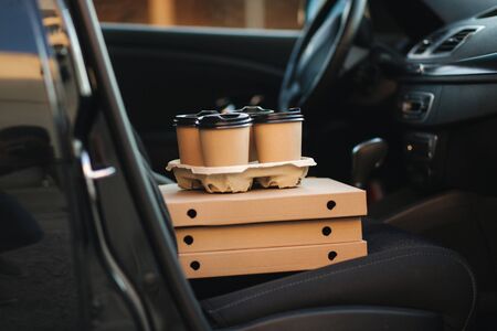 Close up of delivety pizza and coffe in the carの写真素材