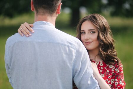 Beautiful woman hug her belowed man. Hand with engagement ringの写真素材