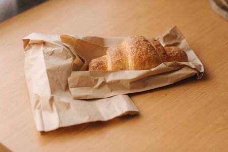 Sroissant on wooden table. Morning at homeの写真素材