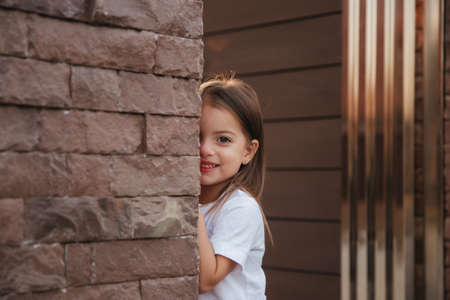 Two year little girl smile to camera in sunsetの写真素材