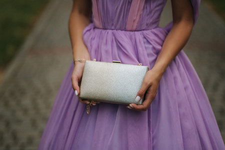 Close up of woman in purple dress hold handbag