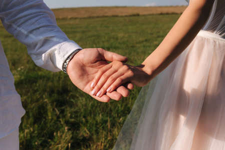 Close up of groom hold brides handの写真素材