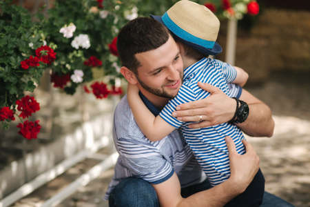 Happy dad with his little sun outdoors. Sun hug his fatherの写真素材