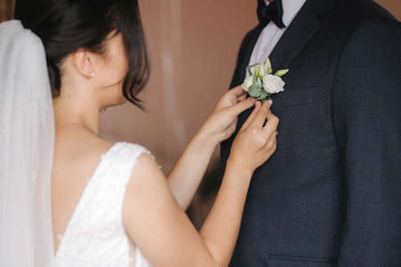 First look of groom and bride at bridess home. Tender bride and handsome groom on their wedding dayの写真素材