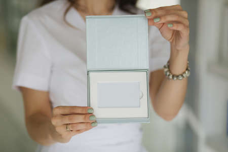 Beautiful medical worker hold gift certificate. Cosmetologistの写真素材