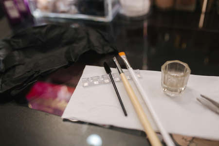 Close-up of working place of brow master. Table with brushes and henna for eyebrowsの写真素材