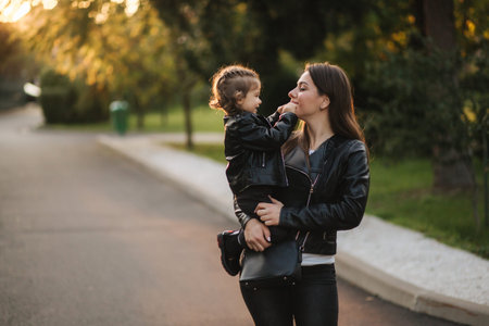 Mom walking with her daughter in the autunm park