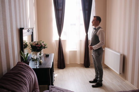 Handsome groom dressed in hotel. Wedding dayの写真素材