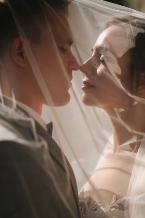 Portrait of groom and bride outdroors. Photo throught the veilの写真素材