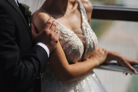 Groom kiss and hug his wife. Bride in elegant wedding dressの写真素材