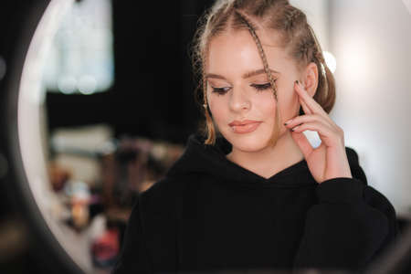 Attractive young woman with nude makeup posint for photo. Portrait of pretty blond hair woman in beauty studioの写真素材