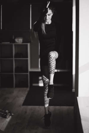 Young athlecit woman jump and have exercise in studio. Balck and white photoの写真素材