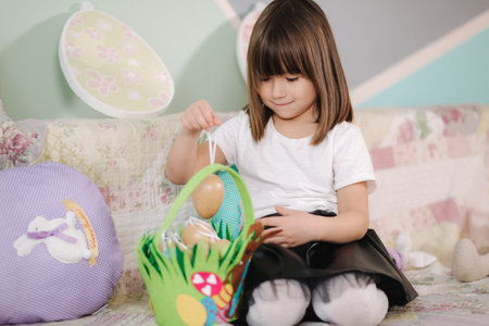 Cute little girl preparing for easter during quarantine. Girl at home