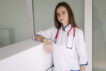 Portrait of a female doctor stand bright modern hospital. medecine conceptの写真素材