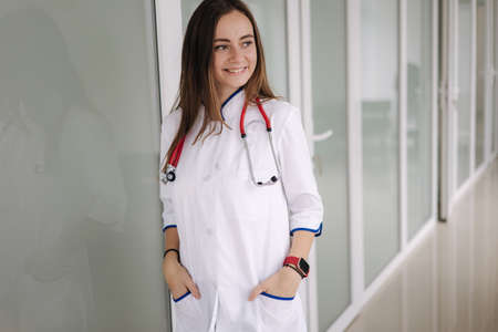 Portrait of a female doctor stand bright modern hospital. medecine conceptの写真素材