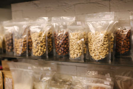 Various nuts packaged in the package for sale at market. Close-up of Healthy vegan foodsの写真素材
