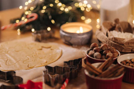 Christmas bakery of gingerbread, cutting cookies of gingerbread dough. Christmas and New Year traditions concept. Candle lightの写真素材