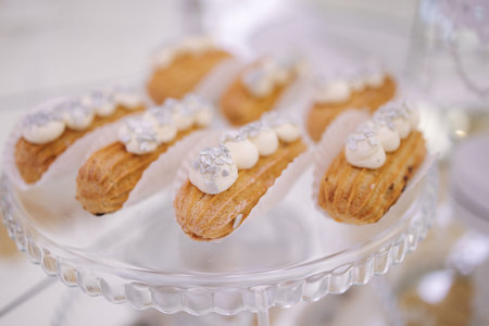 Cake bar on wedding. Differnt type of sweeties on the table. Eclair, cake pops, muffins and mamy...