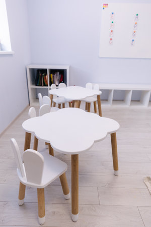 Little white table for kids in private kindergarten. Development and education of childrenの写真素材