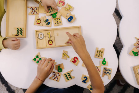 Top view of kids put together educational puzzles