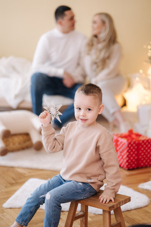 Happy family of mom dad and son spend time at home during winter holidays. Christmas moodの写真素材