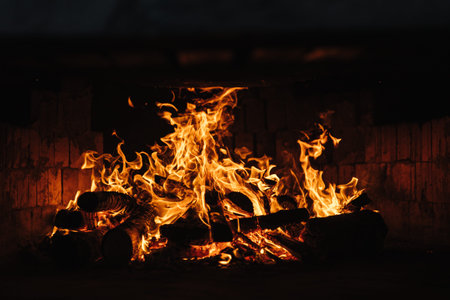 Beautiful bonfire under steaming cast iron hot tub with spa in winter