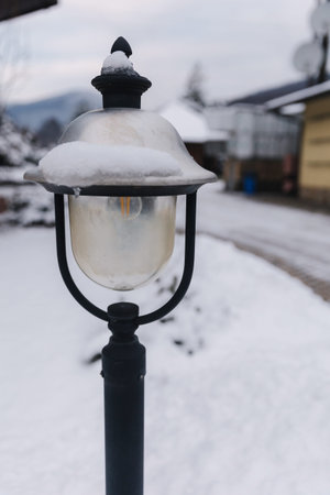 Street lamp covered with snow. Winter weather