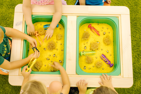 Top view of children with kinetic sand. Hand of little kidの写真素材