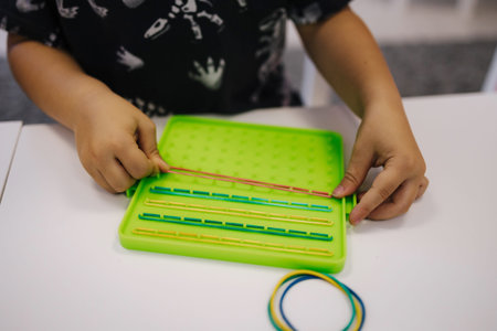 Educational games in kindergarden. Children play using rubber bands
