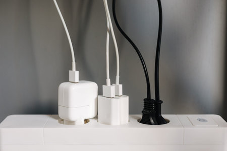 Modern cable connector for overloaded power boards at home. The extension cord is filled with...