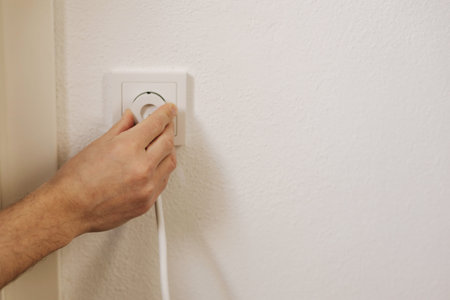 First person view of mans hand puts the charger in the socket